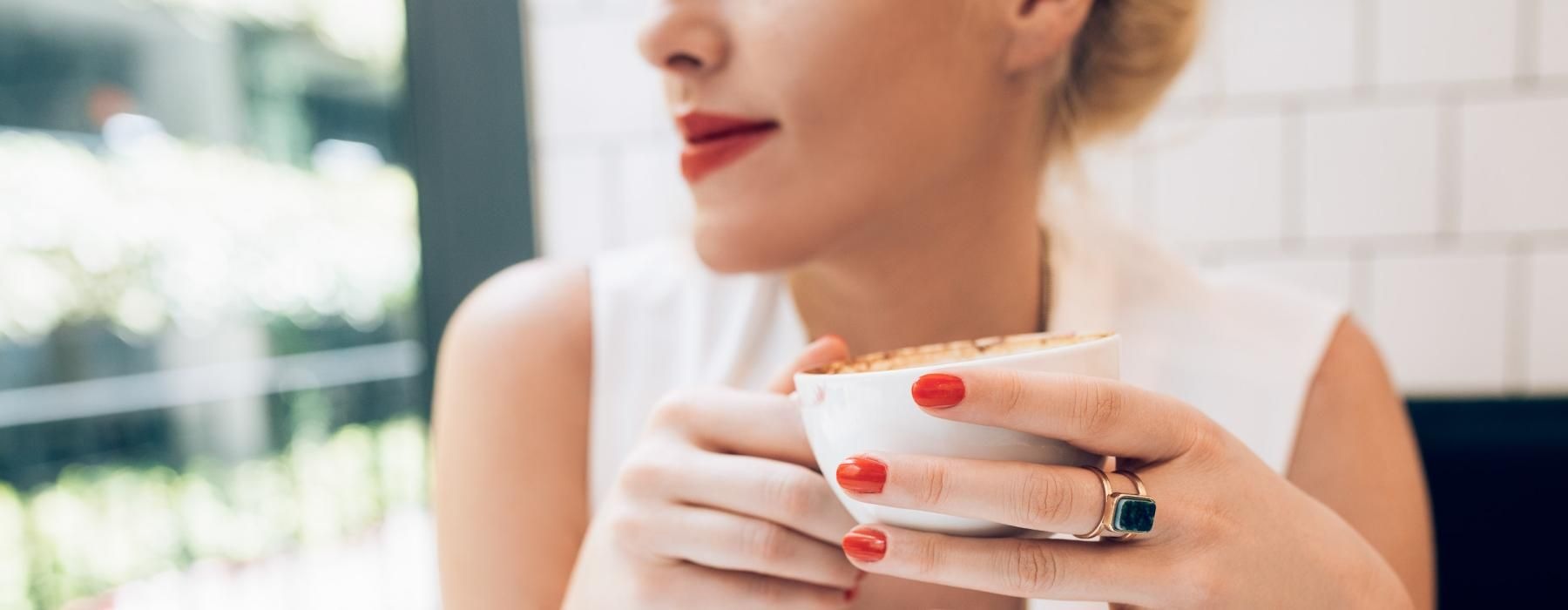 a woman holding a cup